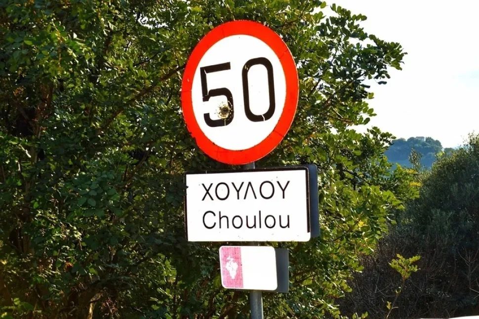 Дорожный знак с названием деревни Хулу Choulou и ограничением скорости 50