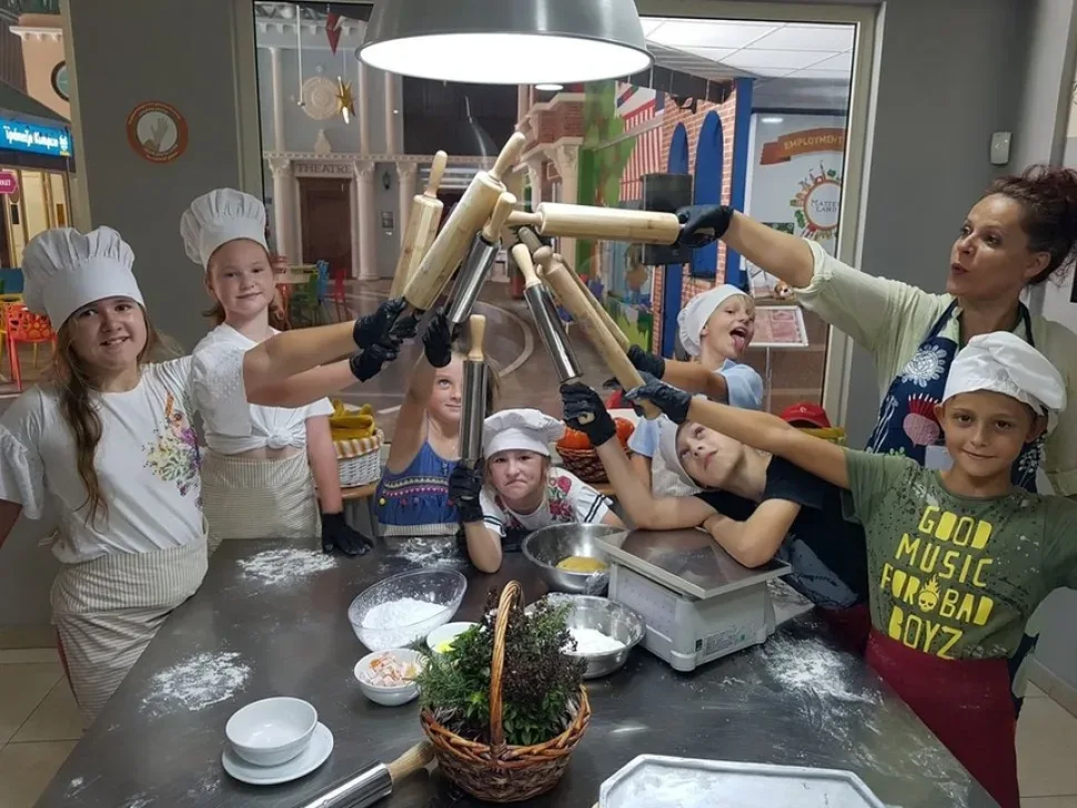 Дети позируют в шляпах с участием аниматора на площадке Masterland Дети позируют в шляпах с участием аниматора на площадке Masterland
