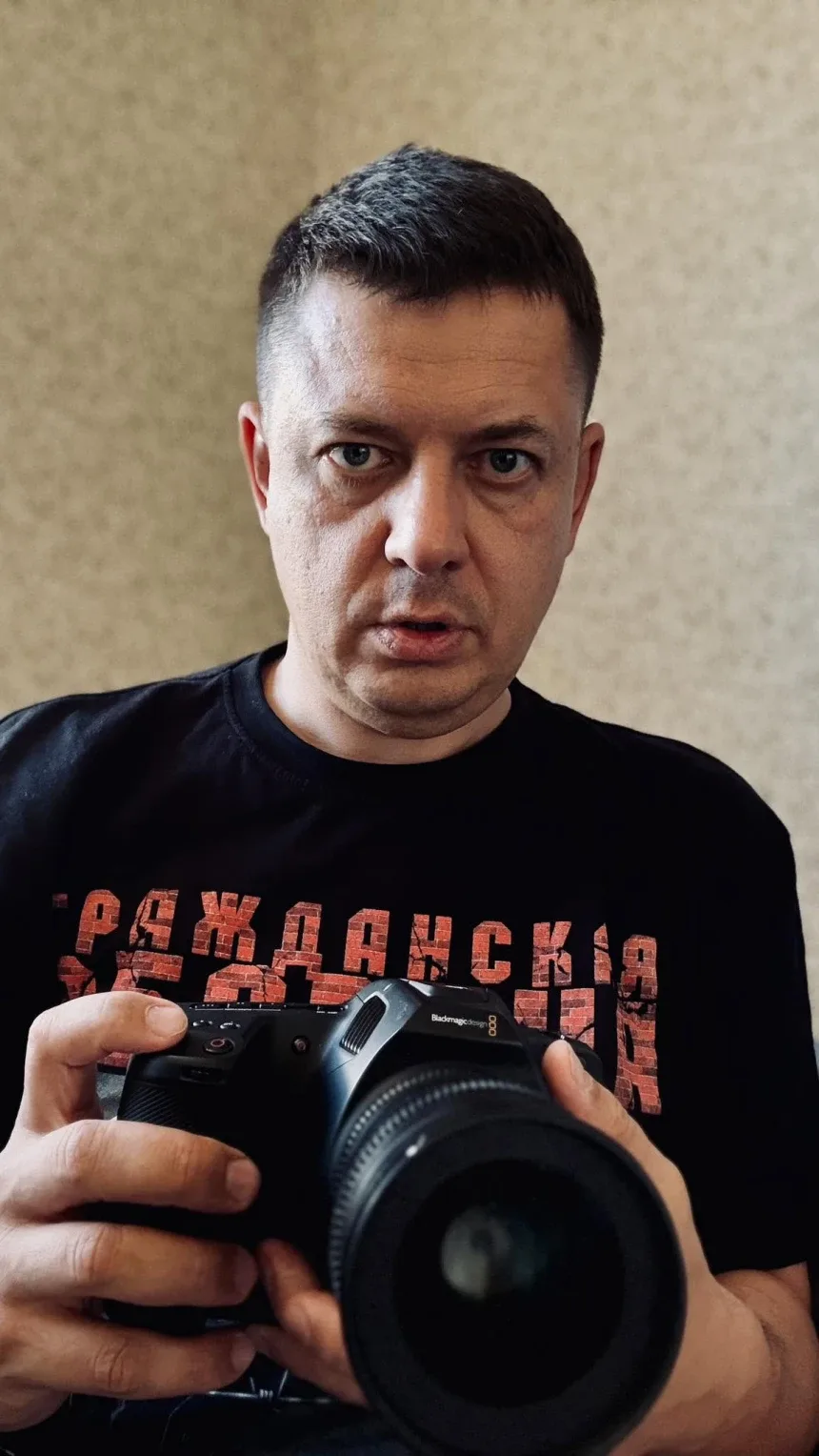Портрет режиссёра с профессиональной камерой в руках Портрет режиссёра с профессиональной камерой в руках