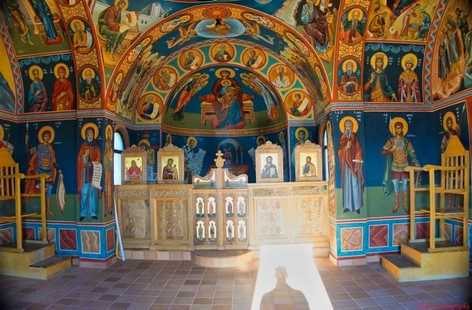 Интерьер часовни с богатой росписью фресок и иконостасом