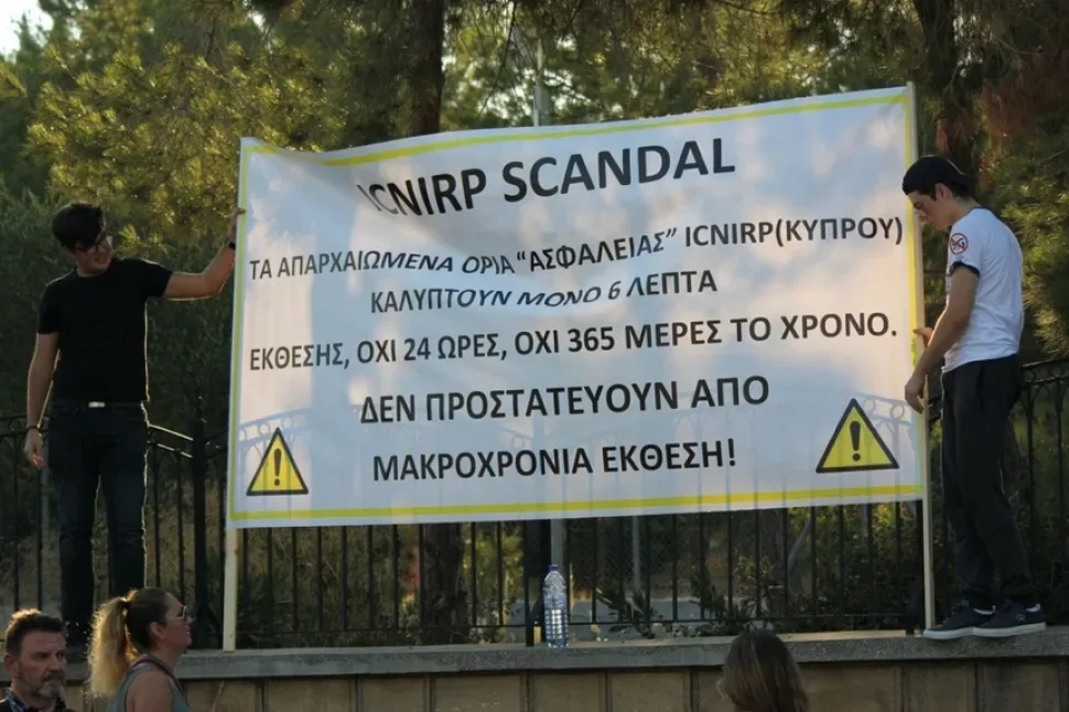 Полицейский кордон у ворот дворца за крупными протестными баннерами на греческом