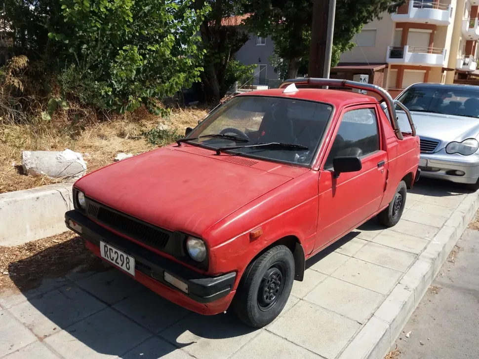 Hyundai Pony Pickup первого поколения припаркованный у тротуара