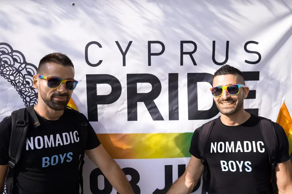 Двое мужчин у баннера Cyprus Pride в солнечный день