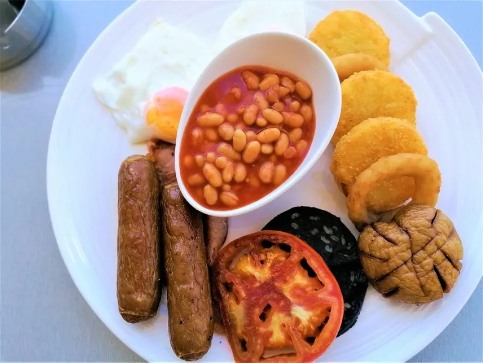 Тарелка с фасолью, сосисками, жареным помидором и грибом английский завтрак