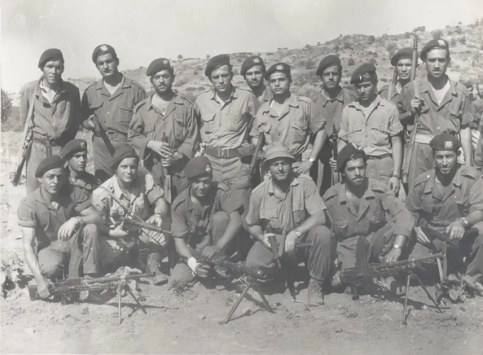 Группа бойцов в военной форме с оружием на открытом участке земли Группа бойцов в военной форме с оружием на открытом участке земли