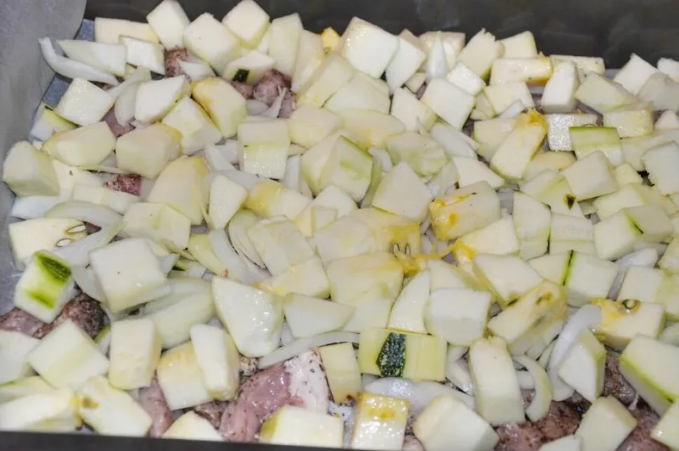 Кубики цукини в миске готовы к солению и укладке слоями
