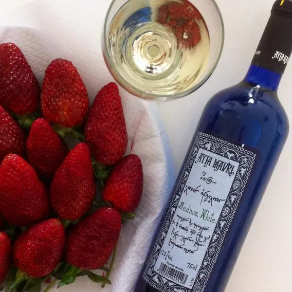Деревянный шкаф с коробками Mosxatos и бутылкой вина с ценником 29€