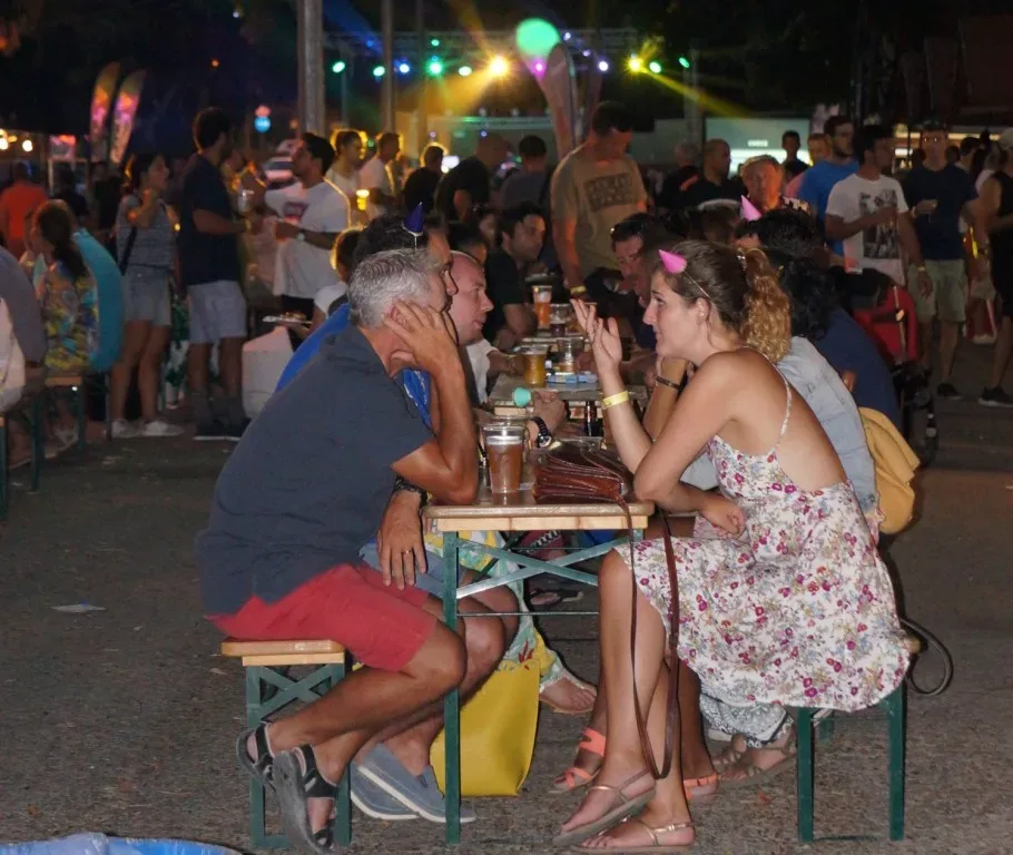 Вечерняя толпа гостей за столиками в разгар Limassol Beer Festival